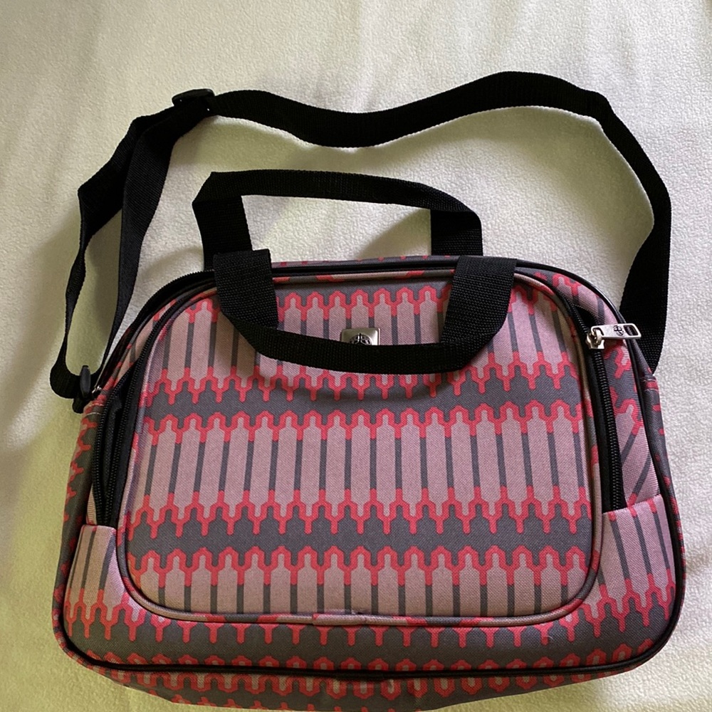 NWOT carry on bag w/ adjustable strap and back strap to attach to suitcase bar!